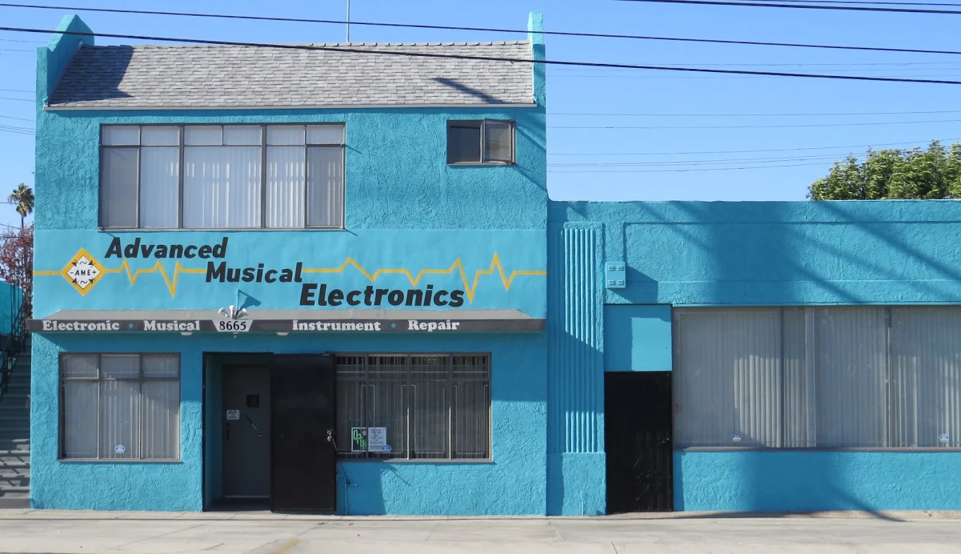 The Advanced Musical Electronics storefront, a teal building on Venice Boulevard with the shop name painted across the front
